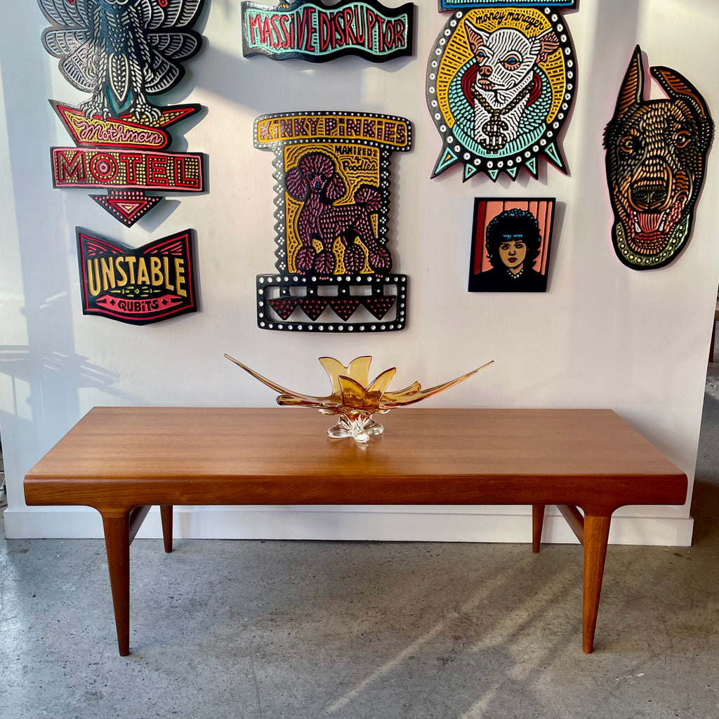 Johannes Andersen Danish modern teak coffee table with tapered legs and softly rounded edges