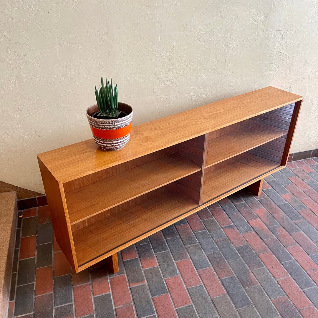  Mid-century Teak Credenza | Hutch with Adjustable Shelving. This mid-century teak credenza | hutch is perfect for storing and displaying your items. Featuring two adjustable shelves, you can customize the configuration to suit your unique home. The timeless design is ideal for both office and home environments.