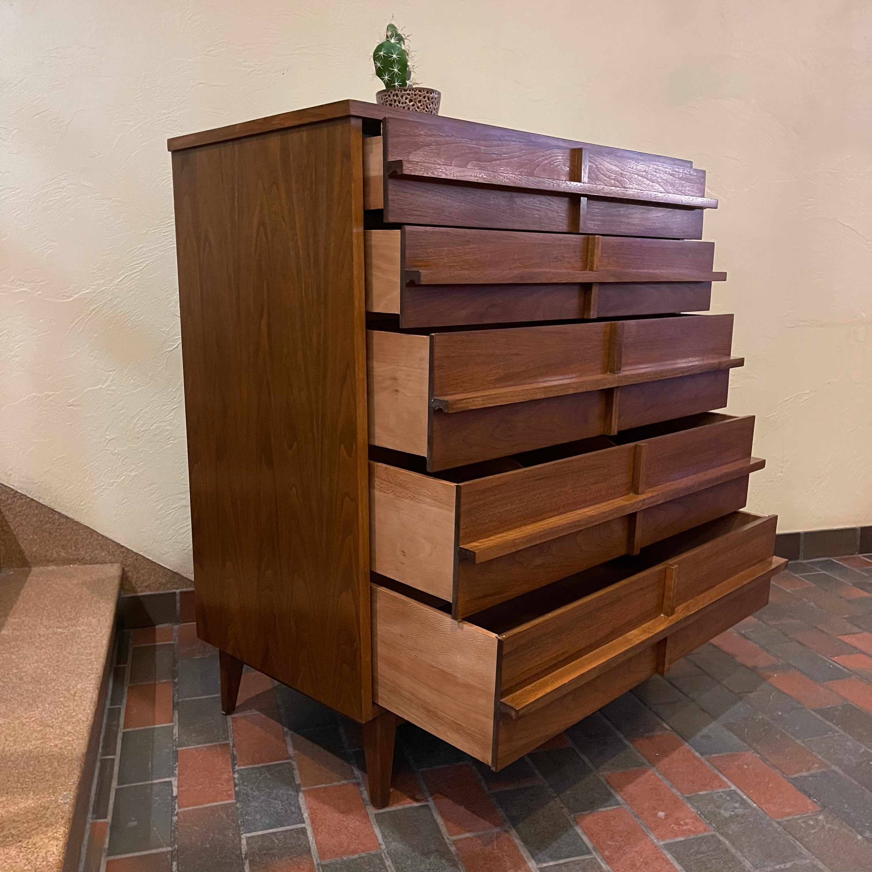 Crafted from rich walnut wood, this GIBBARD dresser boasts a warm, inviting tone that adds a touch of sophistication to any space.