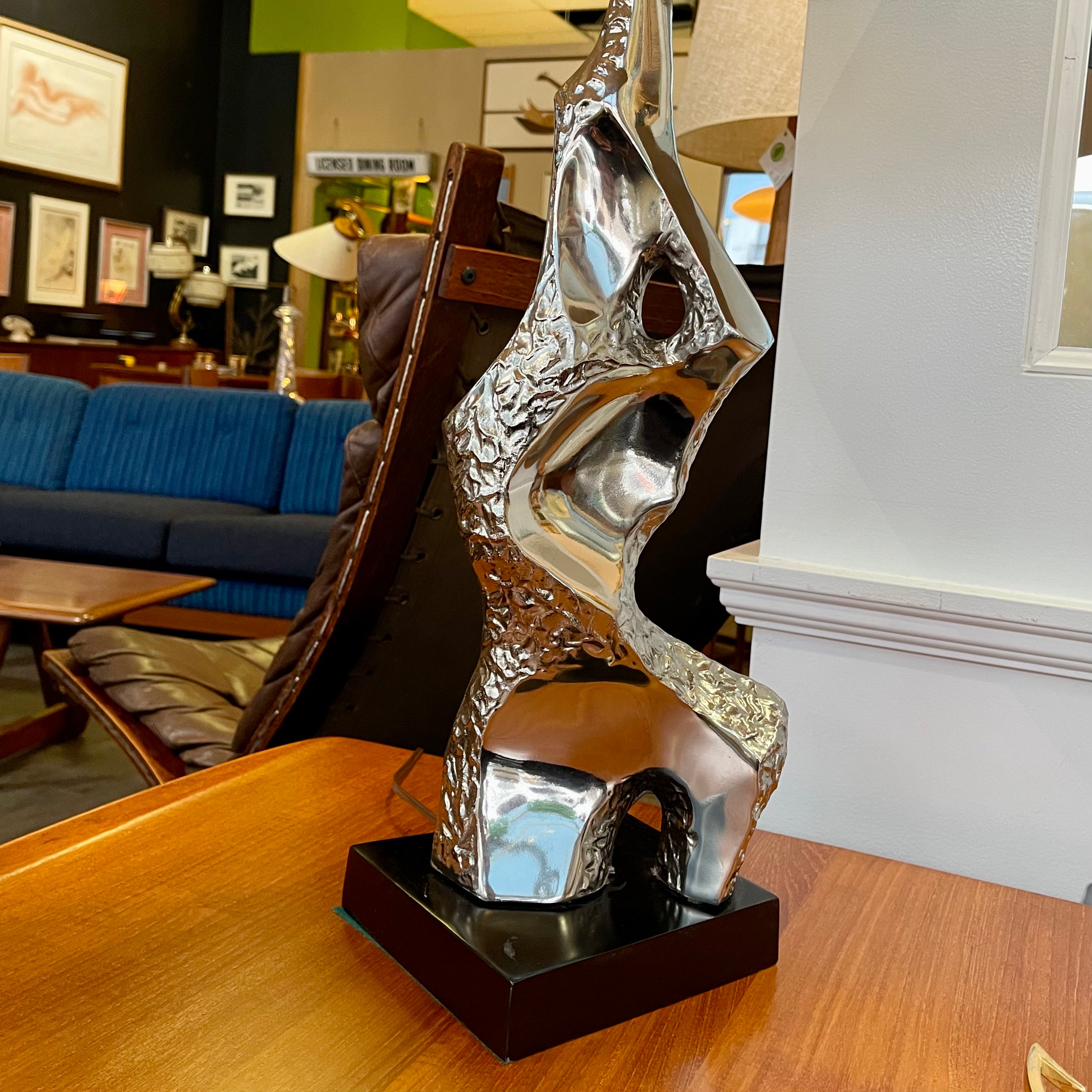 Richard Barr Brutalist Chrome Lamp for Laurel Lamp CoStanding as a testament to the Brutalist movement's influence on mid-century design, the lamp features a robust chrome base that exudes an air of strength and solidity. 