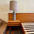 The centerpiece of any bedroom, this platform bed features a clean, minimalist design with a low-profile frame that offers a sense of spaciousness. The headboard, showcasing the natural beauty of teak, adds a touch of organic allure to the overall aesthetic. Its seamless integration with the floating nightstands on both sides creates a cohesive and balanced look.