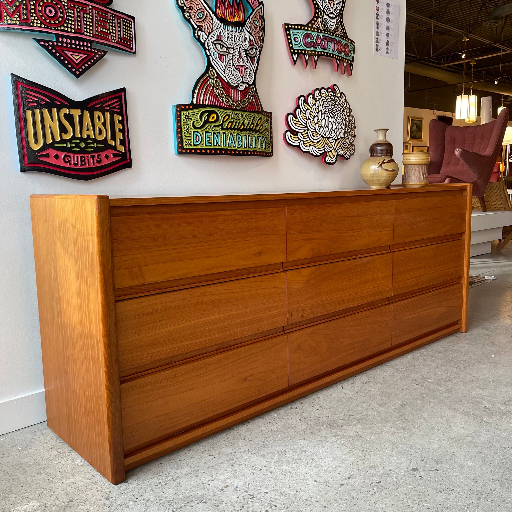 Teak nine drawer dresser with continuous wood grain and integrated pulls