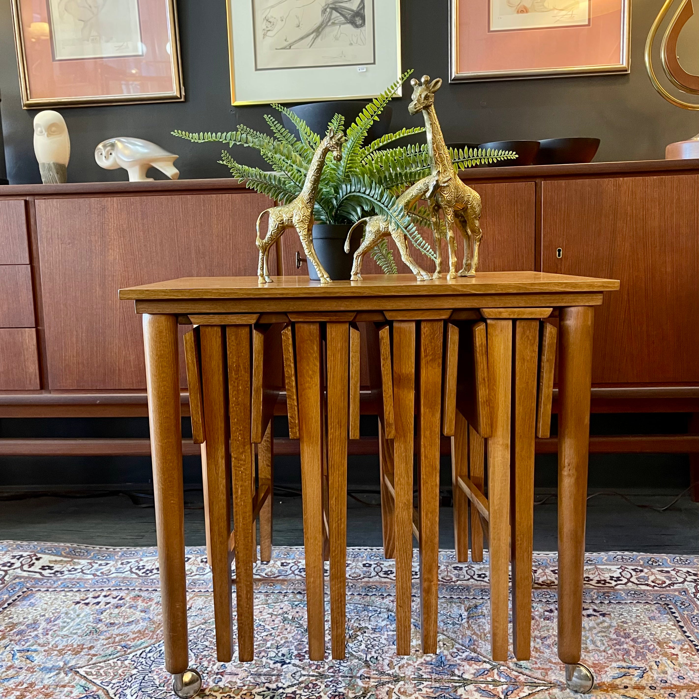 Poul Hundevad Nesting Tables, a timeless and versatile addition to your living space. This exquisite set consists of five tables, with four of them ingeniously designed as drop-leaf tables that effortlessly slide beneath the main table, offering both functionality and aesthetic appeal.