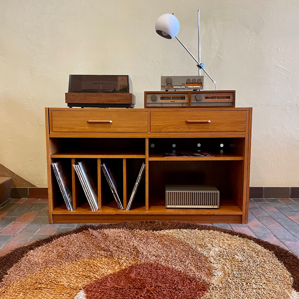 This versatile Adjustable Teak Entertainment Unit is an ideal fit for condo living. With ample storage including two drawers, it accommodates record collections and houses a stereo system