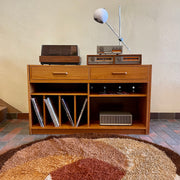 This versatile Adjustable Teak Entertainment Unit is an ideal fit for condo living. With ample storage including two drawers, it accommodates record collections and houses a stereo system