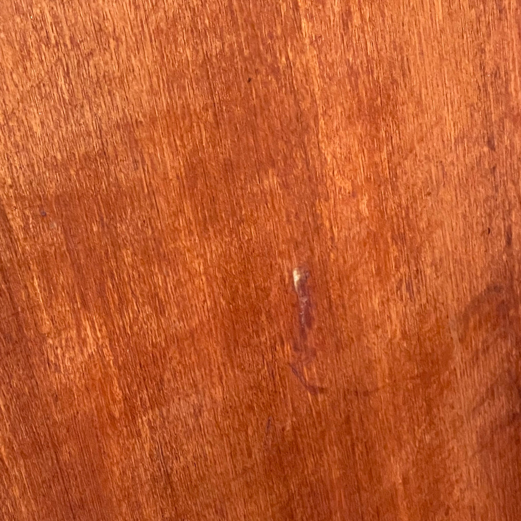 Side view of vintage teak chest of drawers showing light surface wear and scratch on the right side