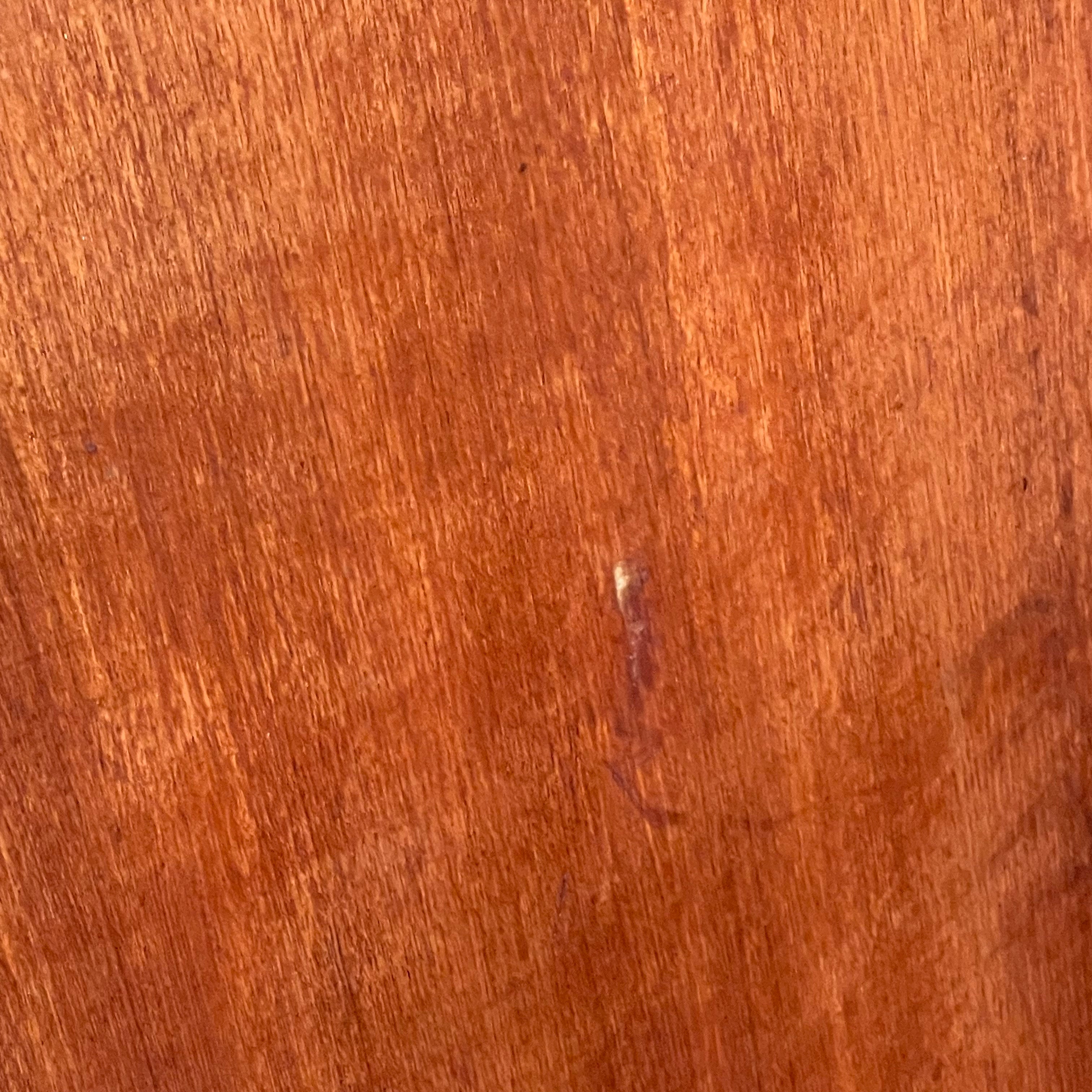 Side view of vintage teak chest of drawers showing light surface wear and scratch on the right side