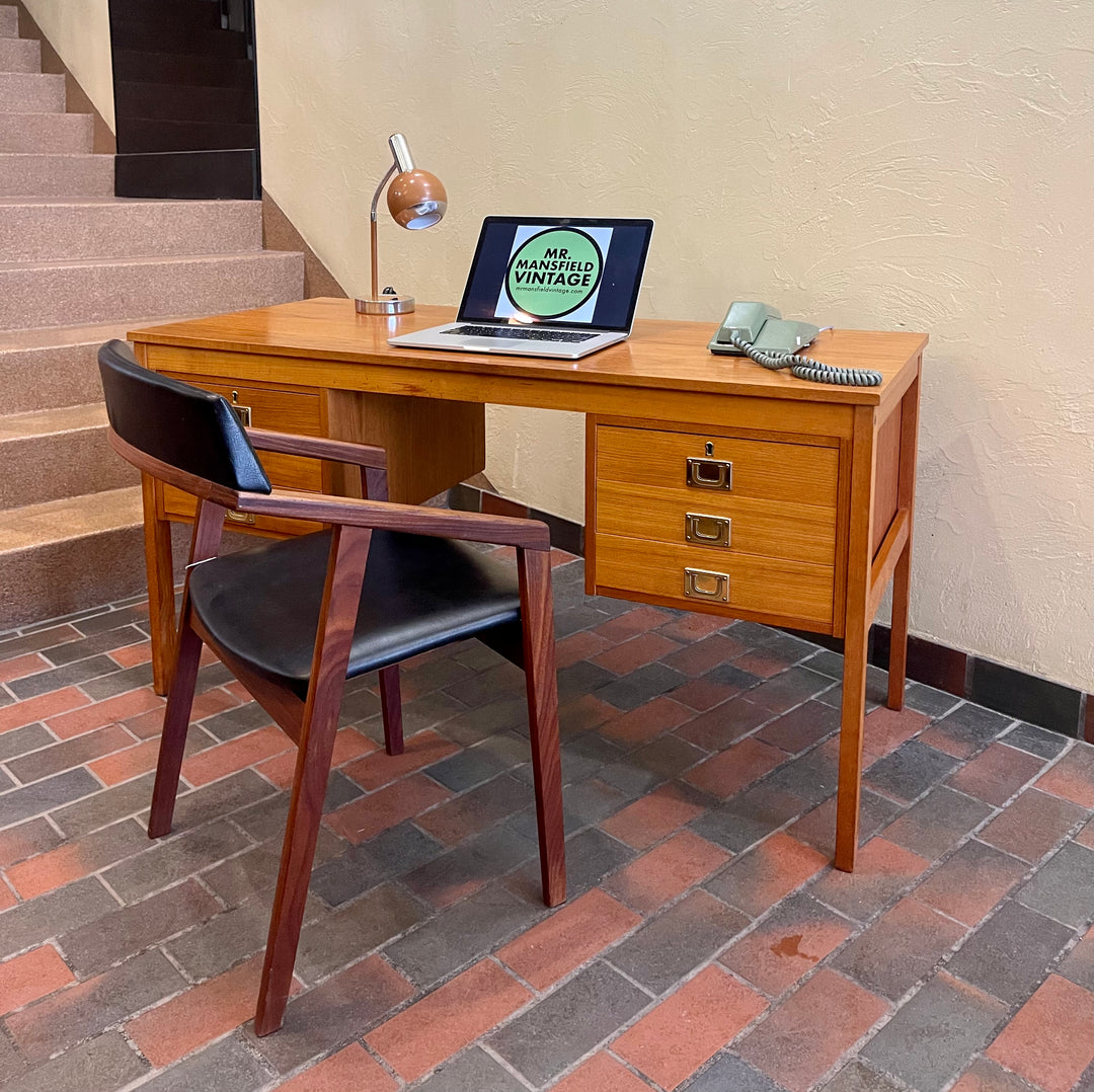 Mid Century Teak Finished Back Desk. This desk has a total of 6 dovetailed drawers, 3 on each side. The pulls are brass adding a classy touch. The two top drawers on either side have locks (missing the key)  The back of the desk is beautifully finished  with teak panels, perfect to place in the middle of the room. 