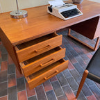 Constructed from rich and durable teak wood, this DYRLUND desk features a design that encapsulates the essence of Mid-Century Modern aesthetics. To the right, a spacious drawer provides practical storage for documents, ensuring a clutter-free workspace. On the left, three drawers offer additional organizational space, perfect for keeping essentials close at hand.