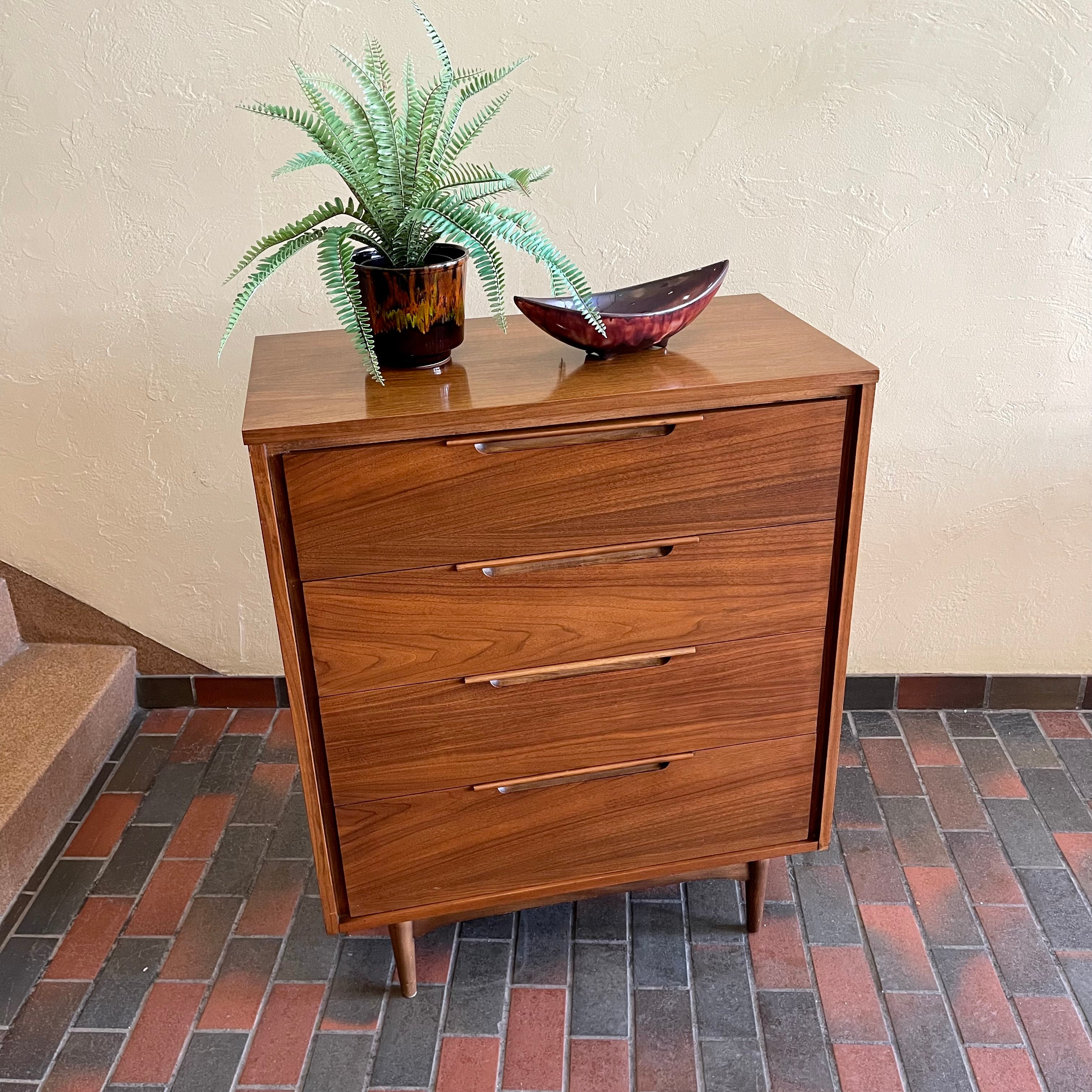 This Vintage KRUG Walnut Tallboy Dresser features four drawers and is made of rich dark walnut wood. Its classic design and high-quality construction make it a timeless addition to any bedroom. 