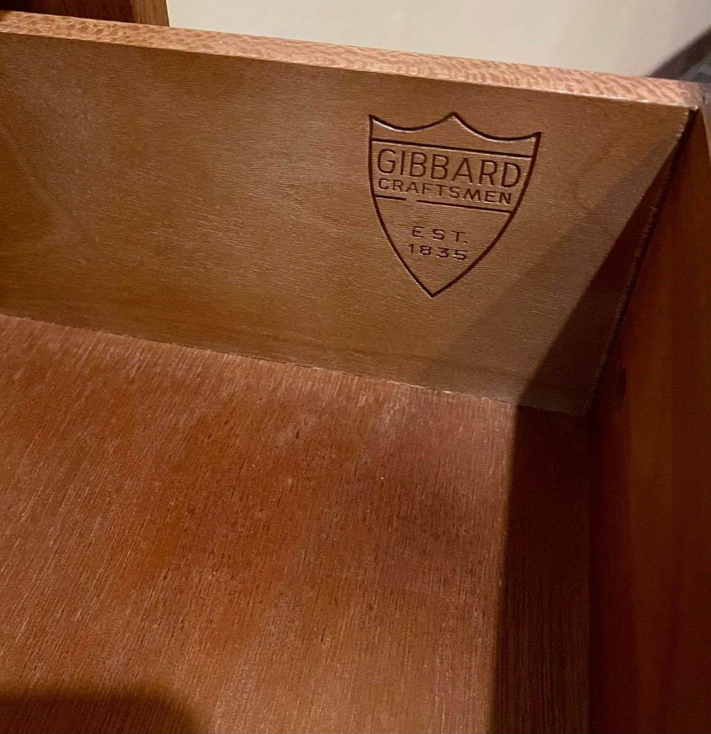 Crafted from rich walnut wood, this GIBBARD dresser boasts a warm, inviting tone that adds a touch of sophistication to any space.