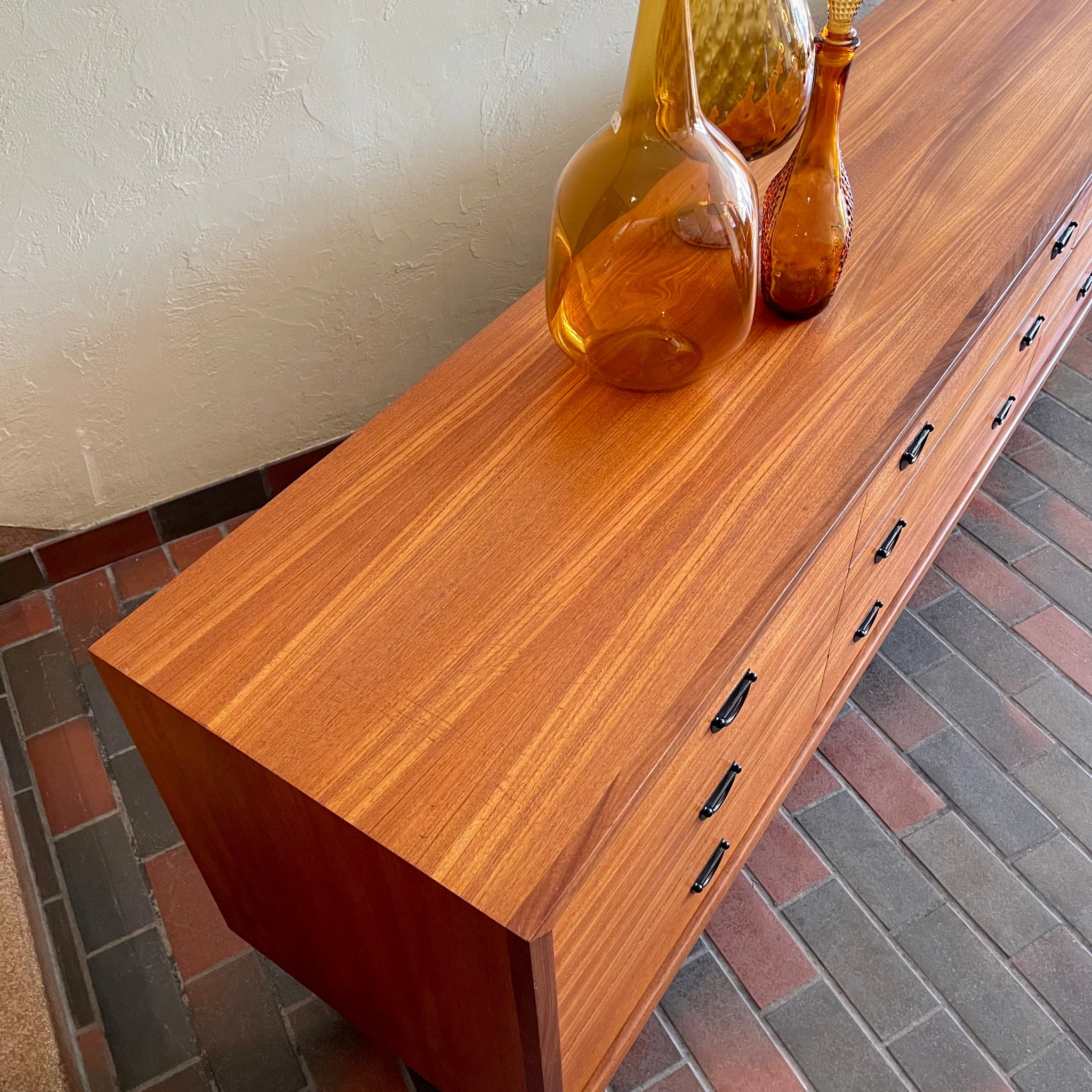 Surface wear detail on vintage R.S. Associates teak nine drawer dresser