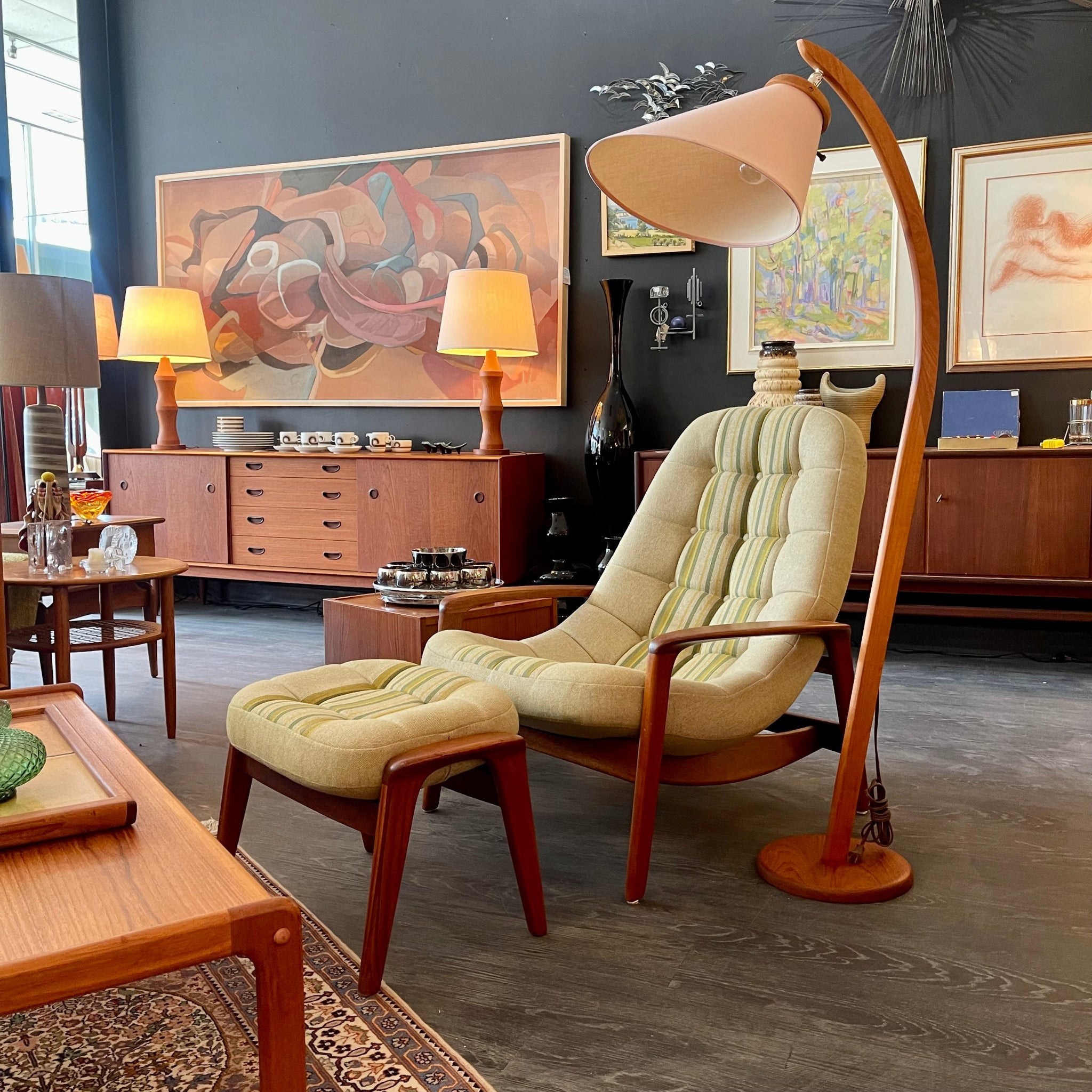 A R. Huber Scoop Chair and Ottoman with midcentury modern design, featuring upholstery in a Main Line Flax Stripe pattern, professionally refinished teak frame, and a contemporary style ottoman with a striped fabric cushion.