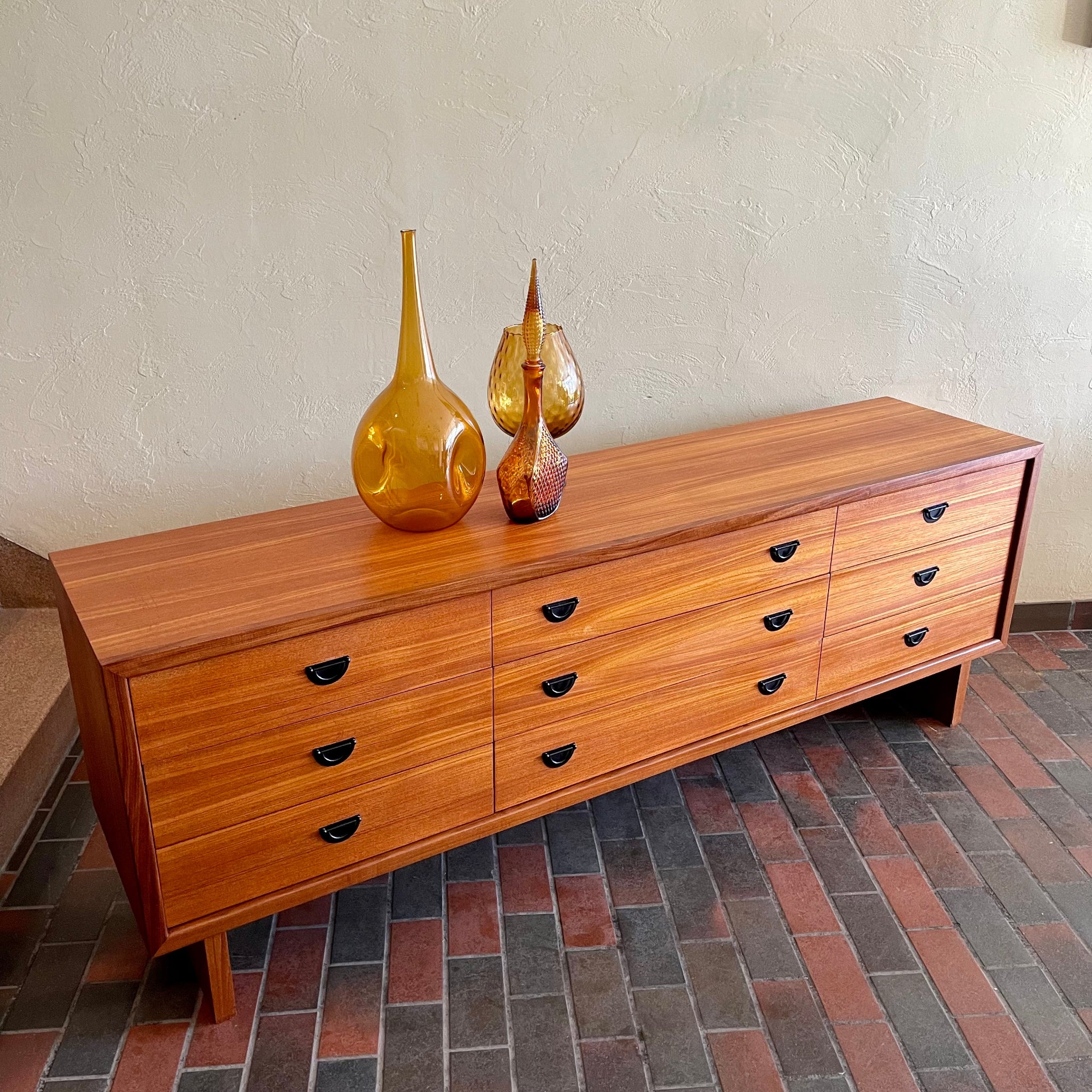 R.S. Associates teak nine drawer dresser with black metal pulls and mid-century credenza profile
