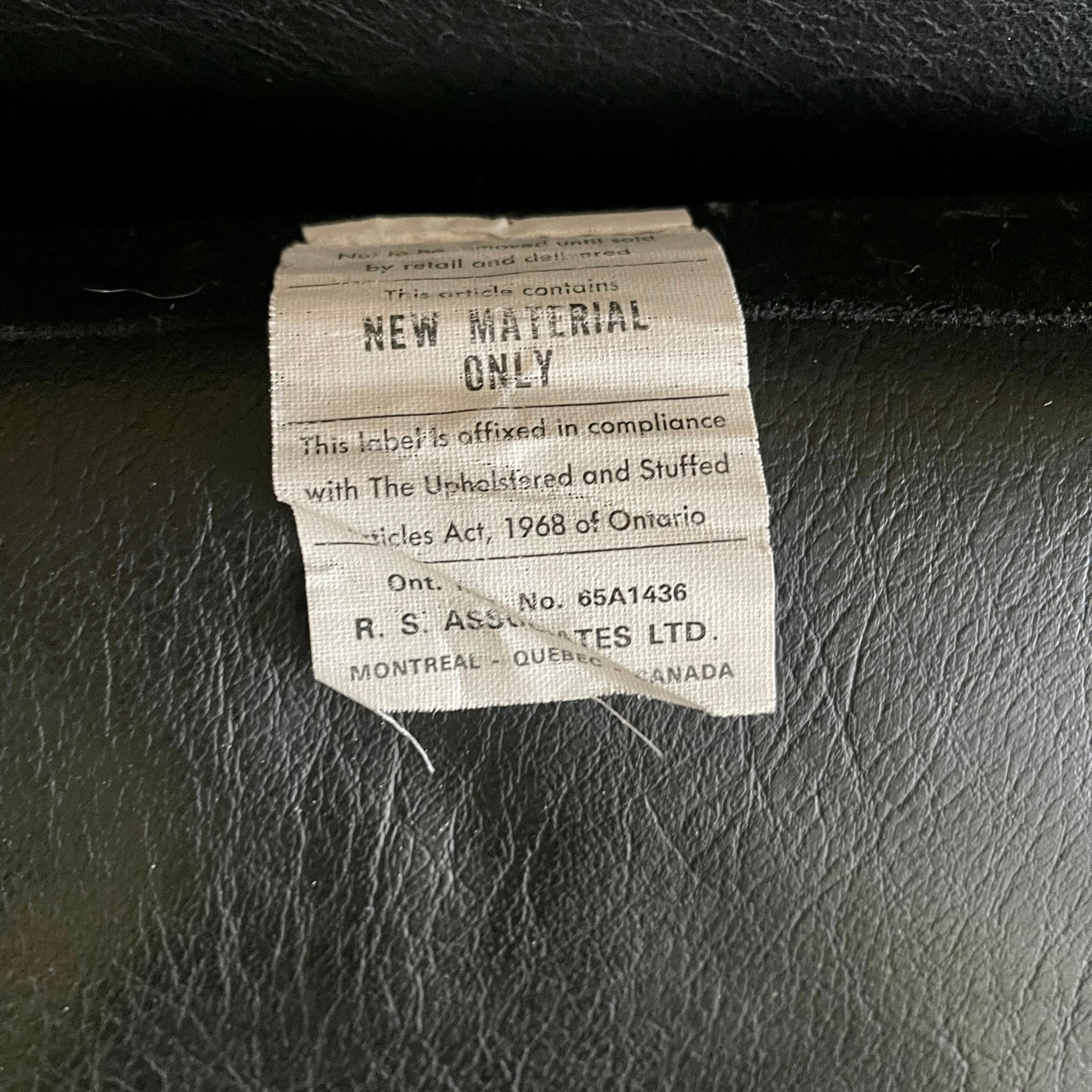 Close-up of RS Associates label on mid-century sofa