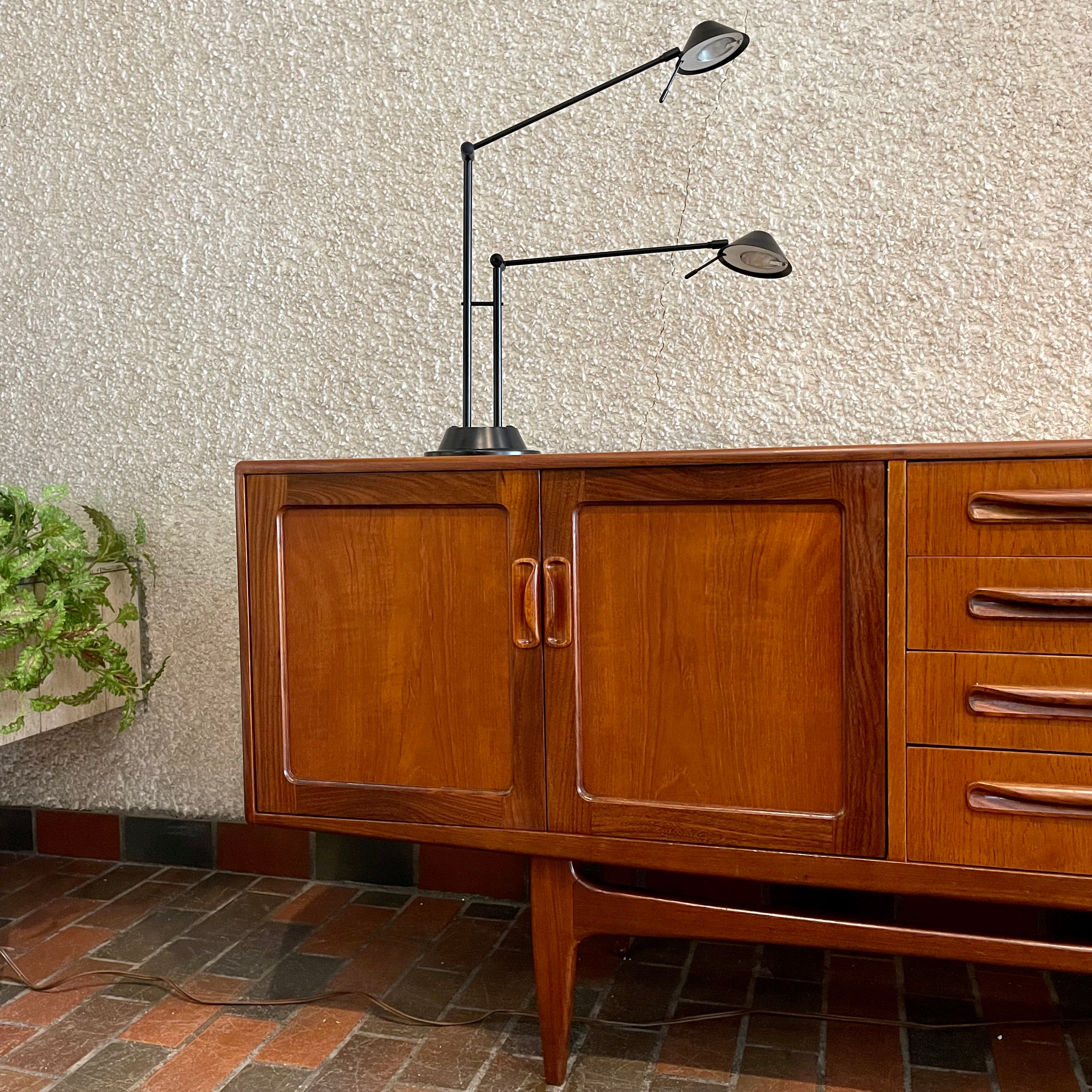 Crafted with attention to detail, this Mid Century Modern "Fresco" Teak Credenza by G Plan features four dovetail drawers for convenient storage, seamlessly integrated with additional storage on either side, offering even more organizational space.
