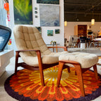 Beige Huber scoop chair with a curved sculptural shape, upholstered seat, teak base and classic vintage modern design.