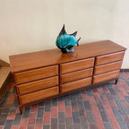 Long walnut bedroom dresser with nine drawers