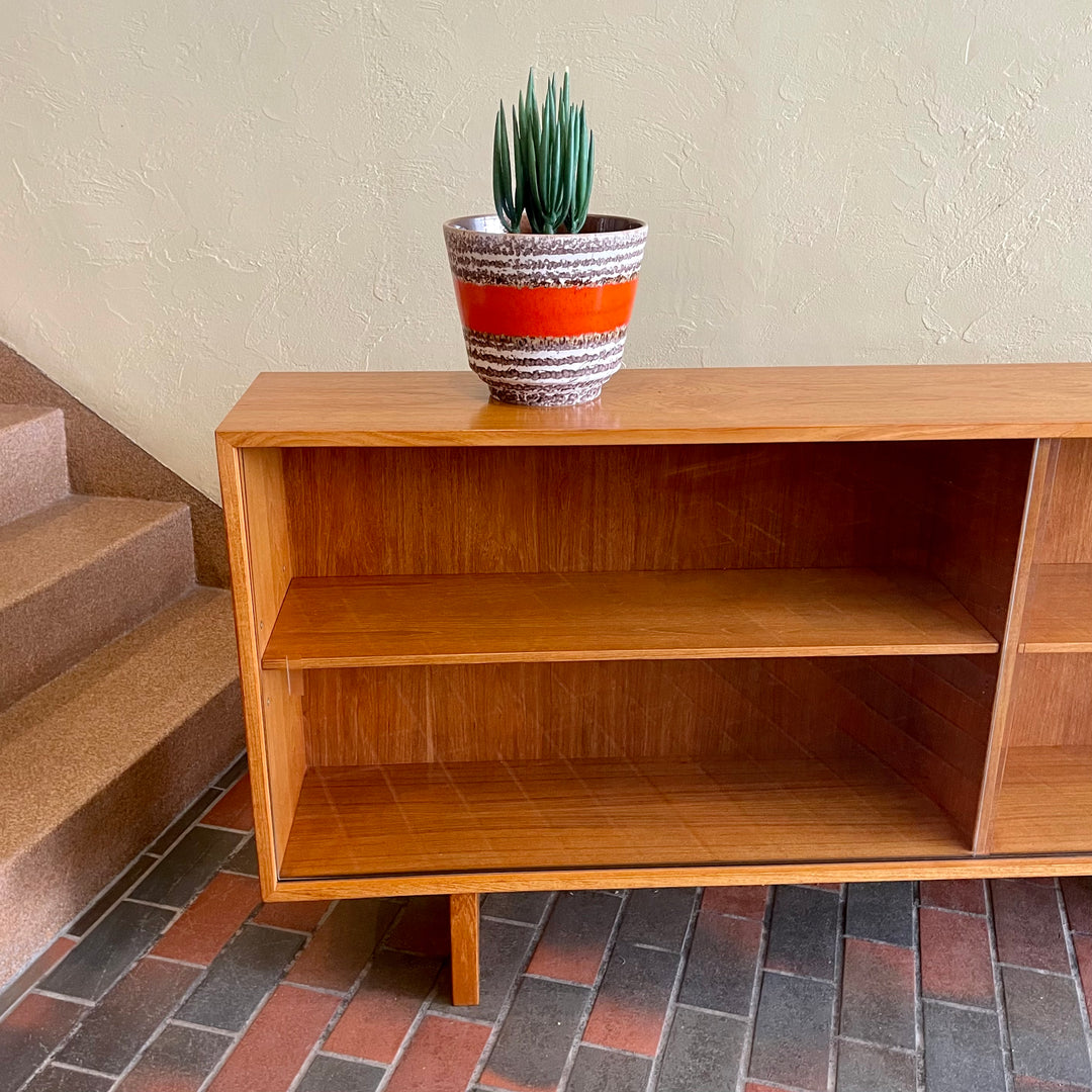  Mid-century Teak Credenza | Hutch with Adjustable Shelving. This mid-century teak credenza | hutch is perfect for storing and displaying your items. Featuring two adjustable shelves, you can customize the configuration to suit your unique home. The timeless design is ideal for both office and home environments.