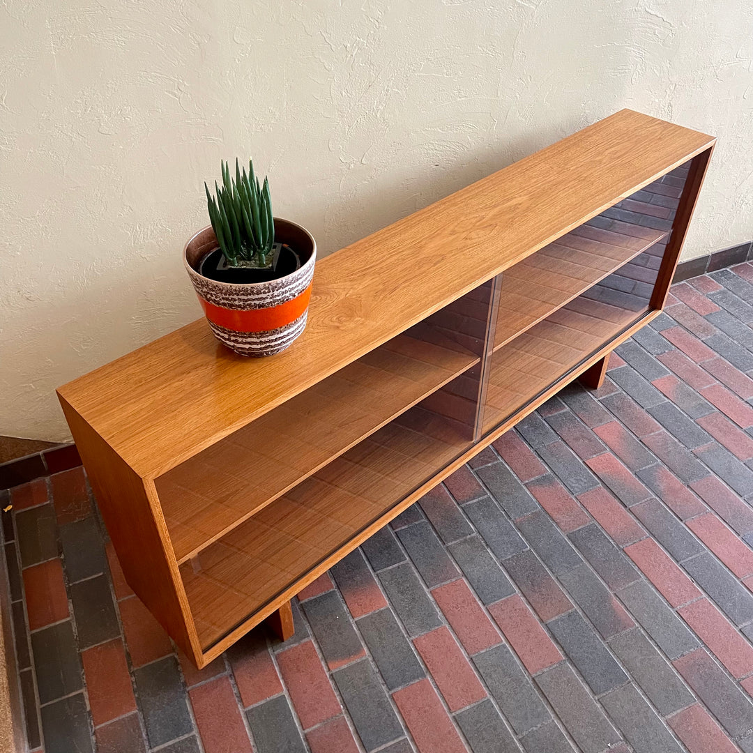  Mid-century Teak Credenza | Hutch with Adjustable Shelving. This mid-century teak credenza | hutch is perfect for storing and displaying your items. Featuring two adjustable shelves, you can customize the configuration to suit your unique home. The timeless design is ideal for both office and home environments.