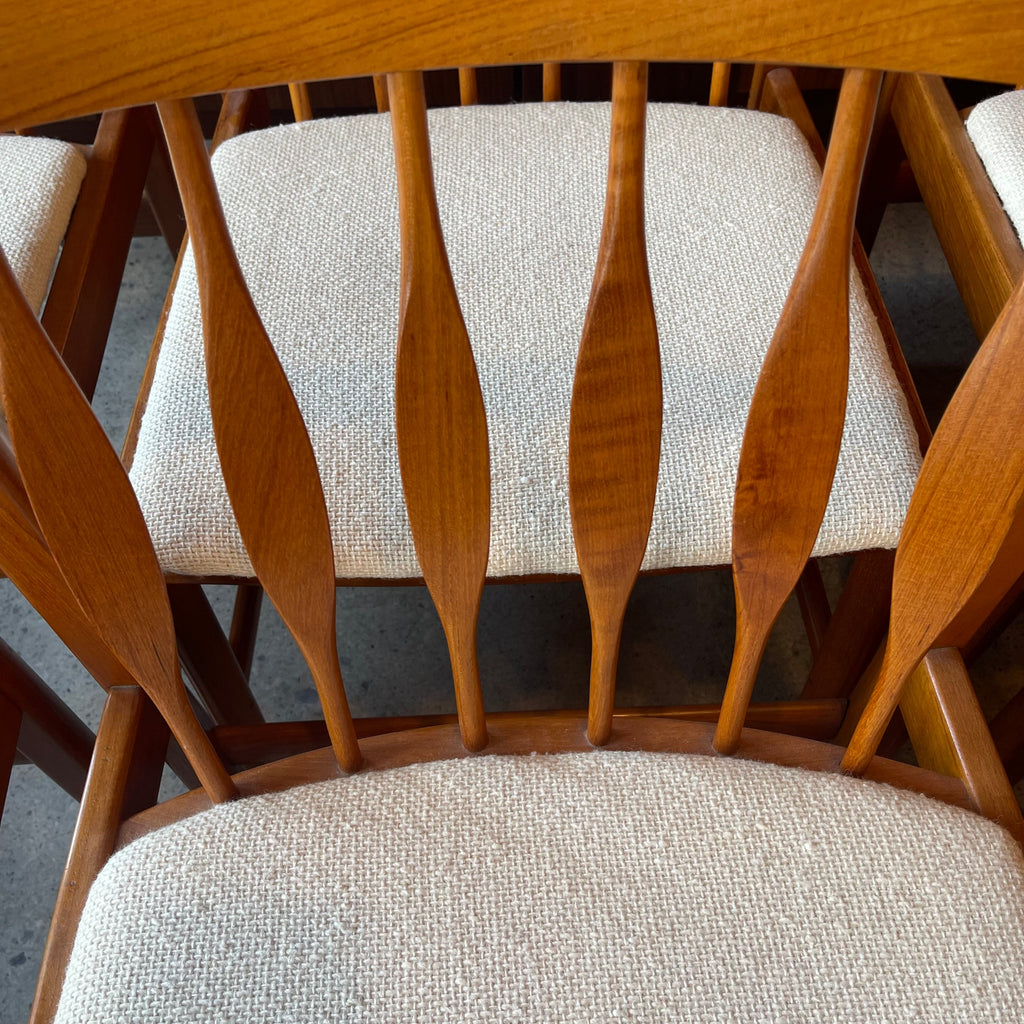 Close-up of RS Associates teak chair back on solid teak dining chair with upholstered seat