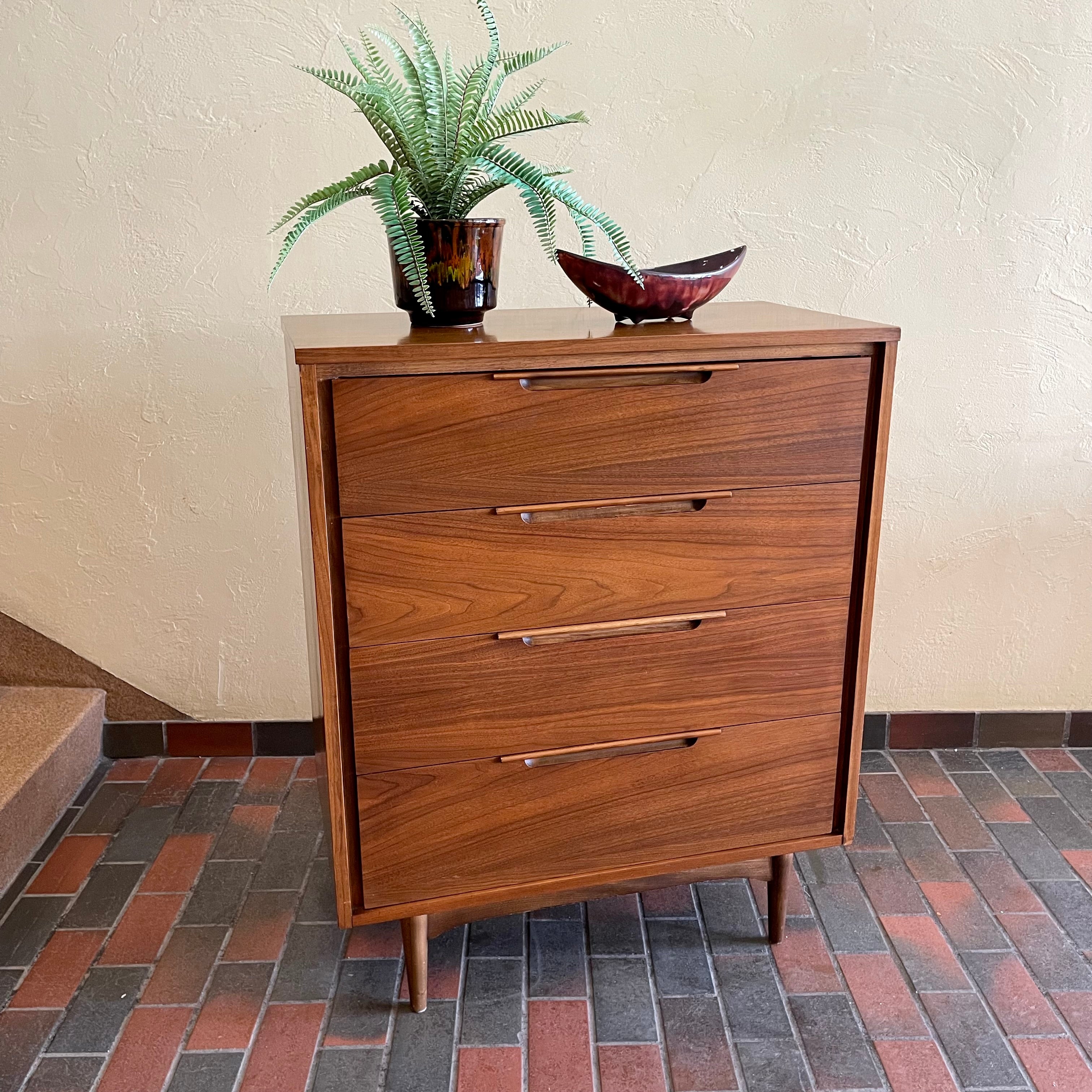 This Vintage KRUG Walnut Tallboy Dresser features four drawers and is made of rich dark walnut wood. Its classic design and high-quality construction make it a timeless addition to any bedroom. 