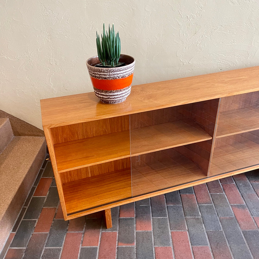  Mid-century Teak Credenza | Hutch with Adjustable Shelving. This mid-century teak credenza | hutch is perfect for storing and displaying your items. Featuring two adjustable shelves, you can customize the configuration to suit your unique home. The timeless design is ideal for both office and home environments.