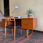 Load image into Gallery viewer, Constructed from rich and durable teak wood, this DYRLUND desk features a design that encapsulates the essence of Mid-Century Modern aesthetics. To the right, a spacious drawer provides practical storage for documents, ensuring a clutter-free workspace. On the left, three drawers offer additional organizational space, perfect for keeping essentials close at hand.

