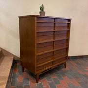 Crafted from rich walnut wood, this GIBBARD dresser boasts a warm, inviting tone that adds a touch of sophistication to any space.