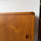 Vintage teak sideboard detail showing warm wood tone