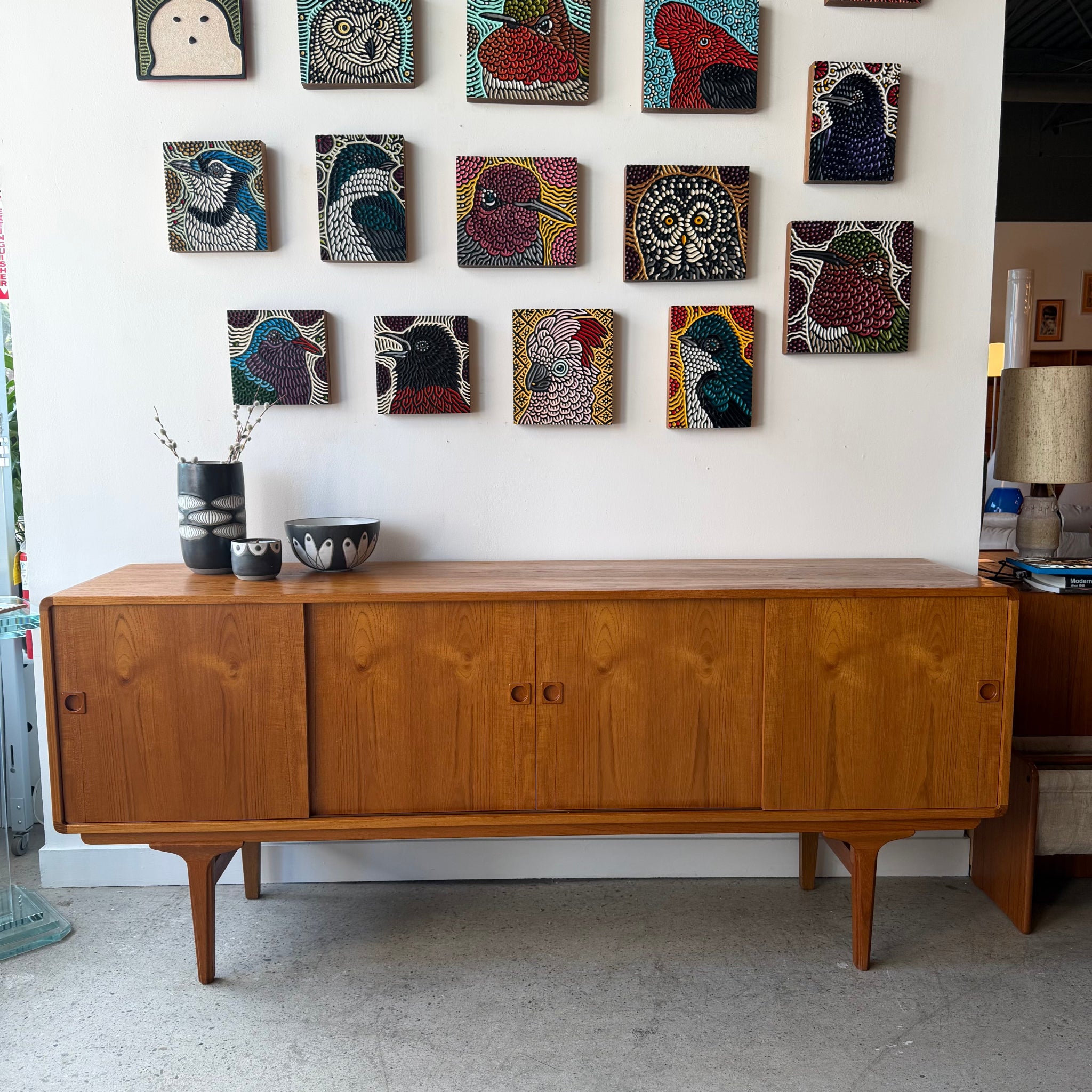 Danish teak sideboard shown with vintage decor display