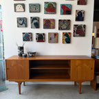 Sliding door storage on mid-century Danish teak sideboard
