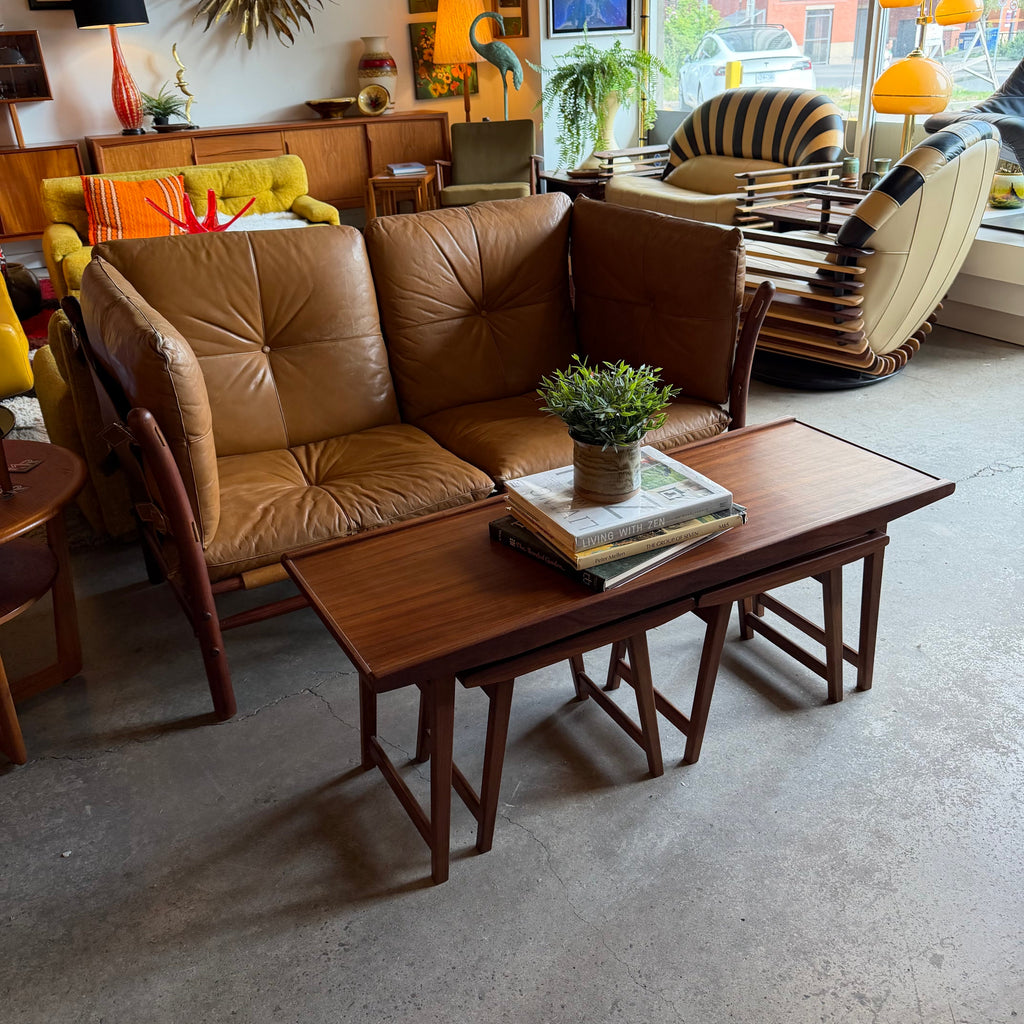 Vintage teak nesting tables styled with leather loveseat