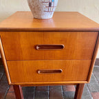 Close-up of handles of two-drawer storage on vintage teak bedside table