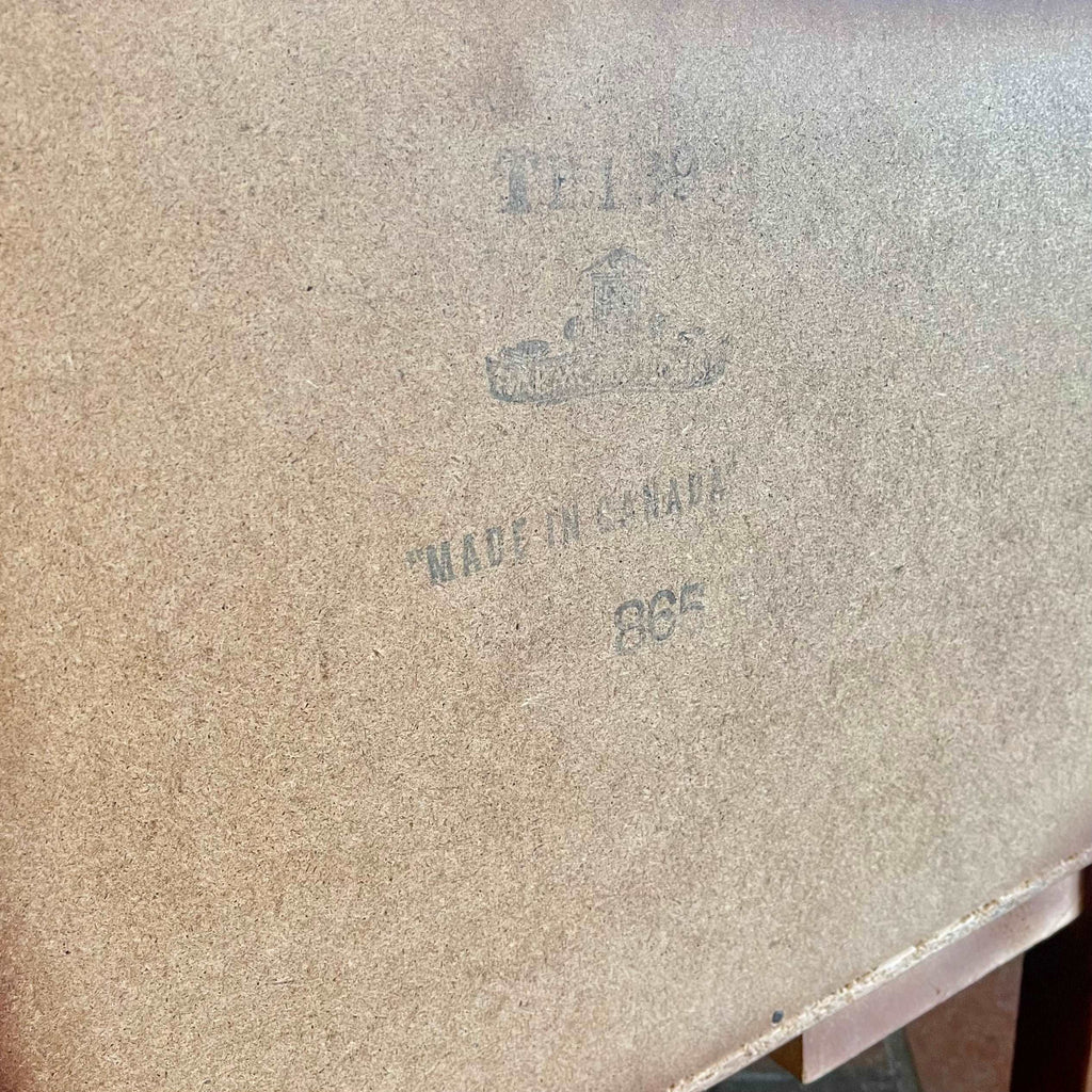 Close-up of Canadian manufacturer’s mark inside vintage teak bedside table drawer