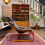 side view of 1970s Kroken lounge chair by Åke Fribytter for Nelo with leather upholstery and curved teak frame 