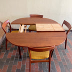 Stamped made in Denmark, the table is unique in that it opens side to side as opposed to end to end. When pulled apart it reveals a fold out butterfly leaf.  When the table is closed it is an oval shape but when open it’s more of a "square with rounded corners" 