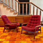 Pair of R. Huber scoop lounge chairs with teak frames and original upholstery