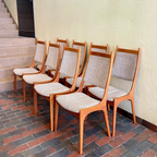 Set of R. Huber teak dining chairs with oatmeal upholstered seats