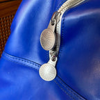 Close-up of hardware on vintage blue airline travel bag