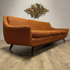 Angled view of House of Braemore atomic style sofa showing original patterned upholstery