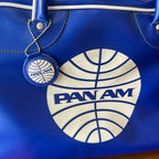 Close-up of PAN AM logo on vintage blue airline travel bag