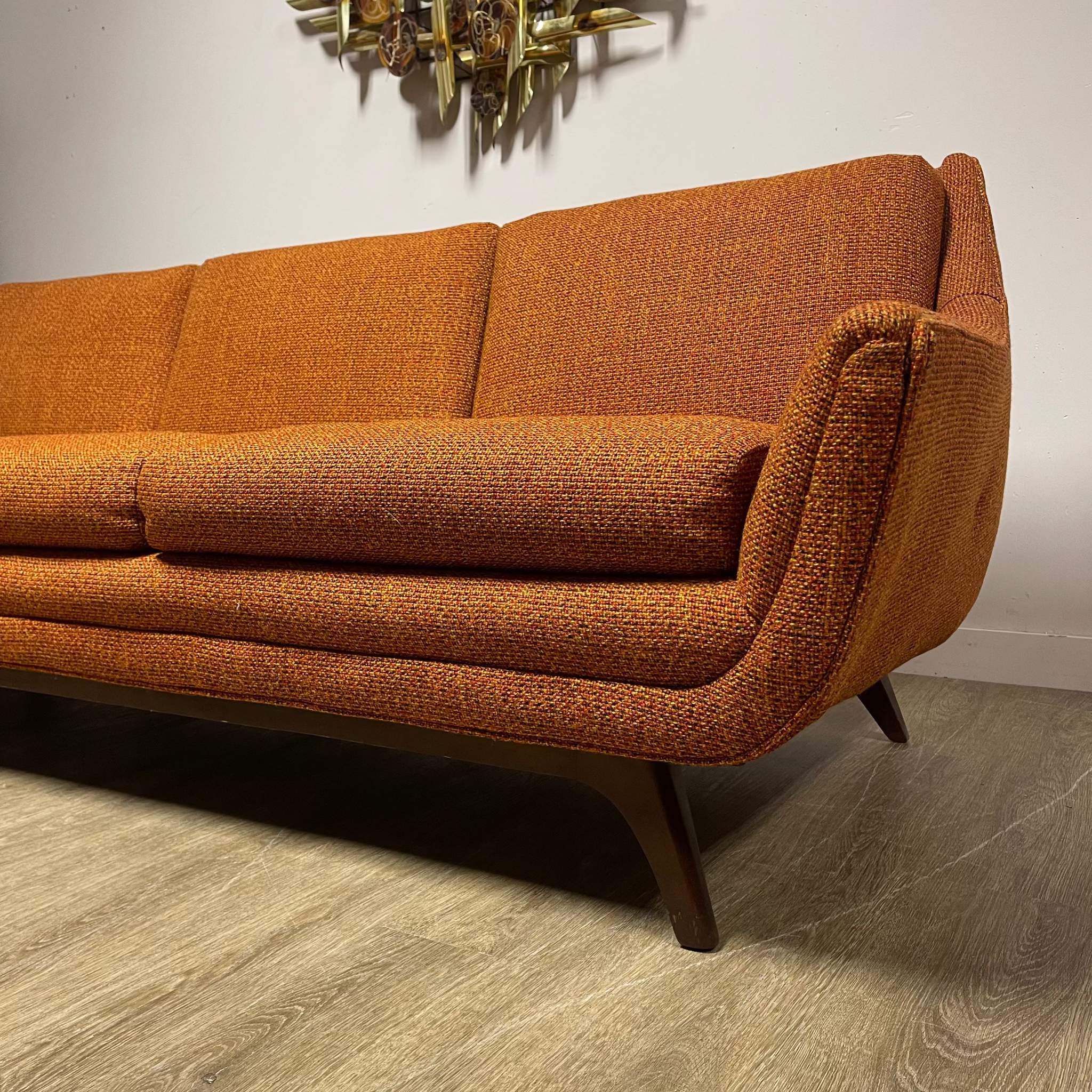Angled view of House of Braemore atomic style sofa showing original patterned upholstery