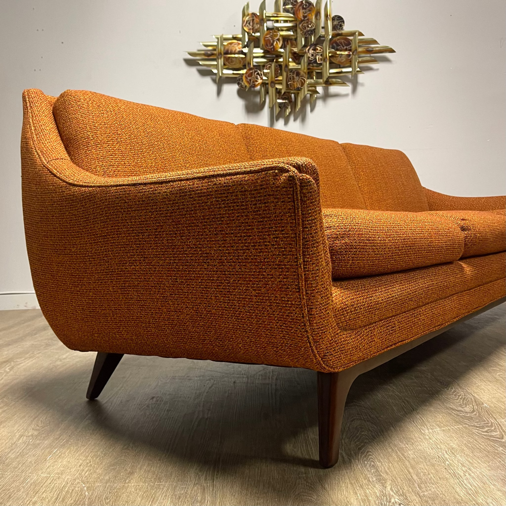 Close-up of original burnt orange House of Braemore sofa fabric with red black and gold flecks