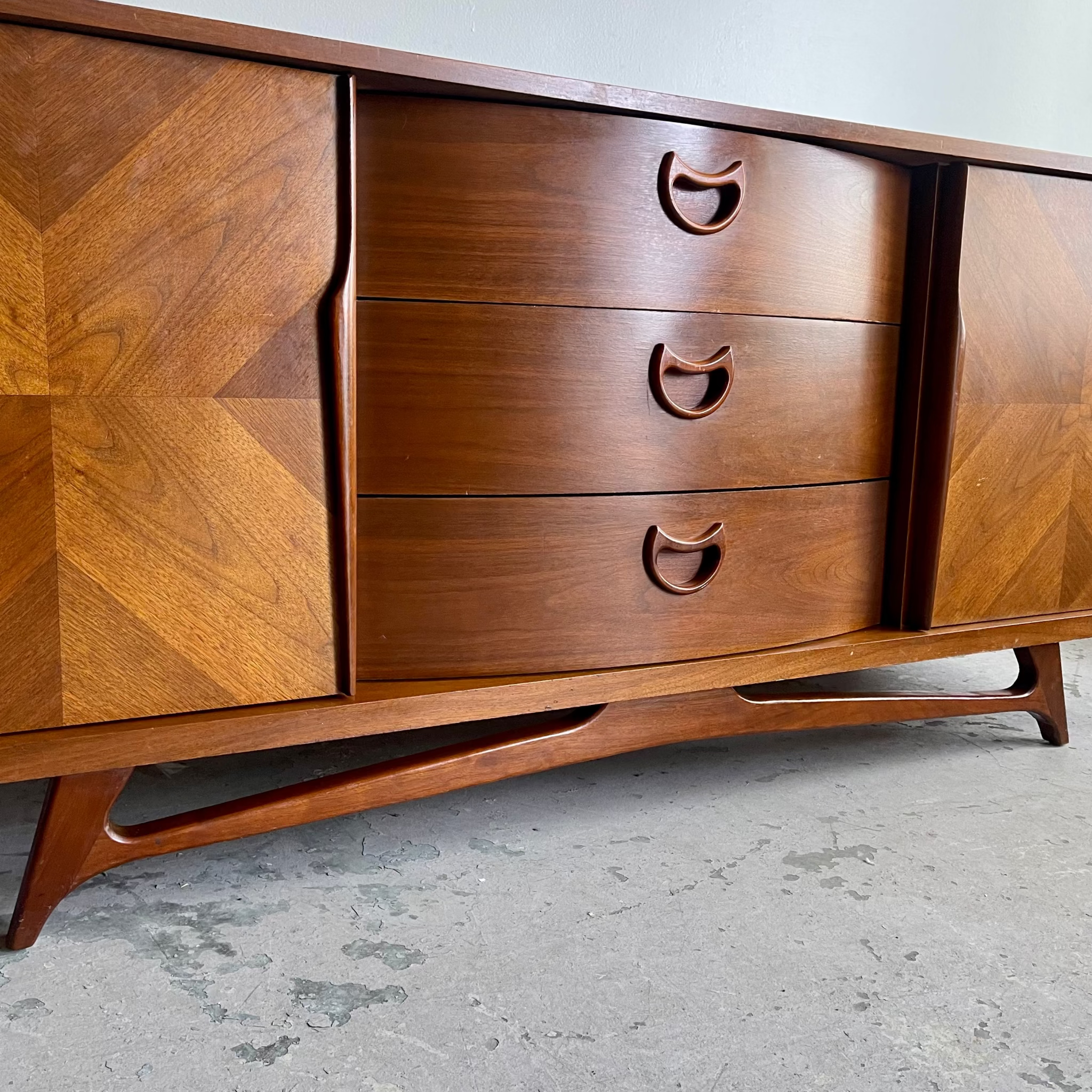 Drawer handle detail on vintage VISCOL walnut dresser