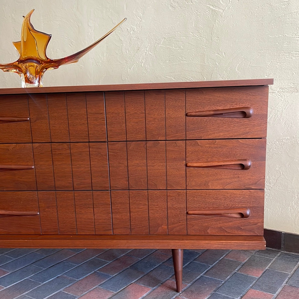 Close-up of Viscol Victoriaville walnut dresser showing sculpted mid-century drawer handles